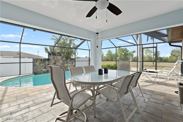 sunroom / solarium with ceiling fan and a pool