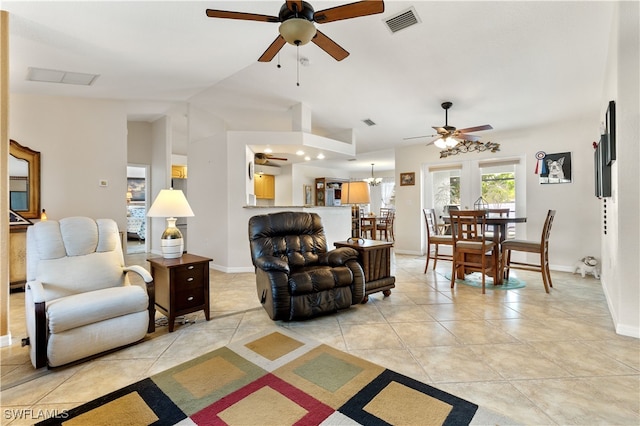 tiled living room with ceiling fan with notable chandelier