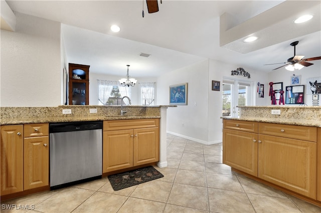 kitchen with decorative light fixtures, sink, light stone counters, and stainless steel dishwasher