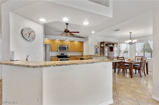 kitchen with hanging light fixtures, kitchen peninsula, appliances with stainless steel finishes, and ceiling fan with notable chandelier