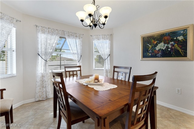 tiled dining space with a chandelier