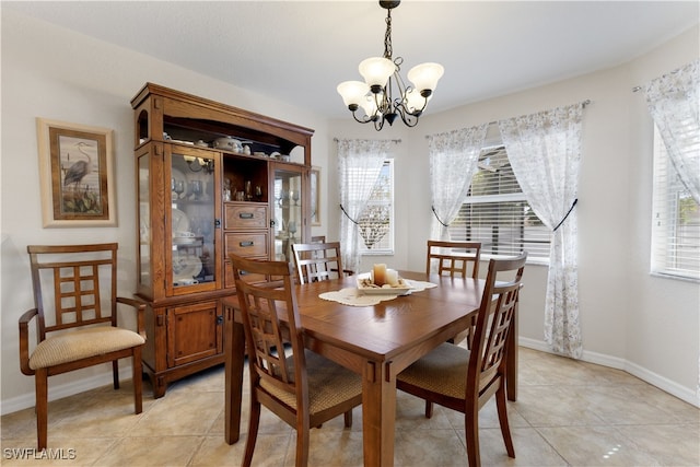 tiled dining space with a notable chandelier