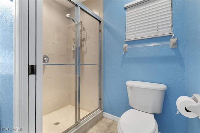 bathroom featuring toilet, walk in shower, and tile patterned flooring