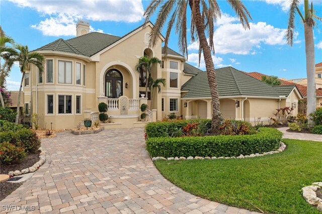 view of front of property with a front lawn and french doors