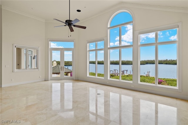 unfurnished room featuring ceiling fan, a high ceiling, french doors, ornamental molding, and a water view