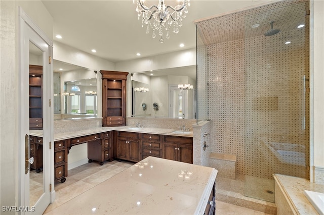 full bathroom with double vanity, a notable chandelier, walk in shower, and a sink