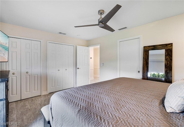 bedroom with multiple closets and ceiling fan