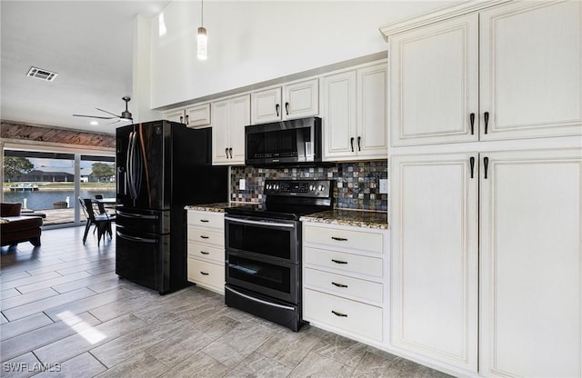 kitchen featuring backsplash, range with two ovens, light stone counters, black fridge with ice dispenser, and a water view