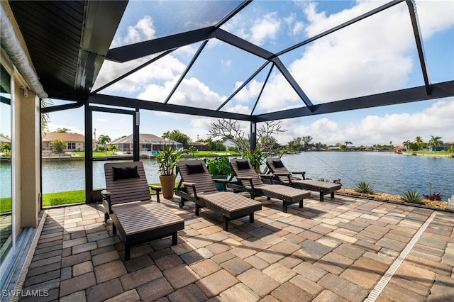 view of patio / terrace featuring a water view and a lanai