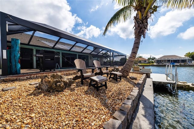 exterior space featuring a water view, a lanai, and a dock