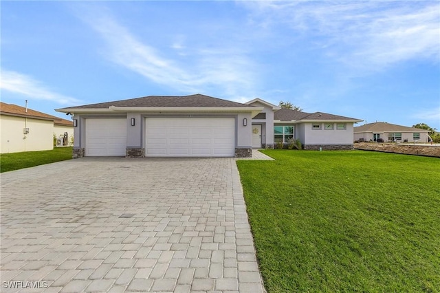 single story home with a garage and a front lawn