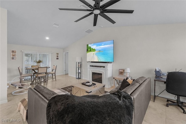 living room featuring ceiling fan, lofted ceiling, a high end fireplace, and light tile patterned floors