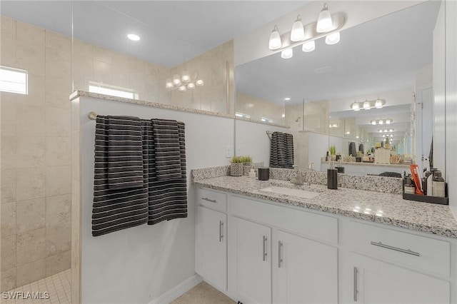 bathroom featuring vanity, tile patterned floors, and walk in shower