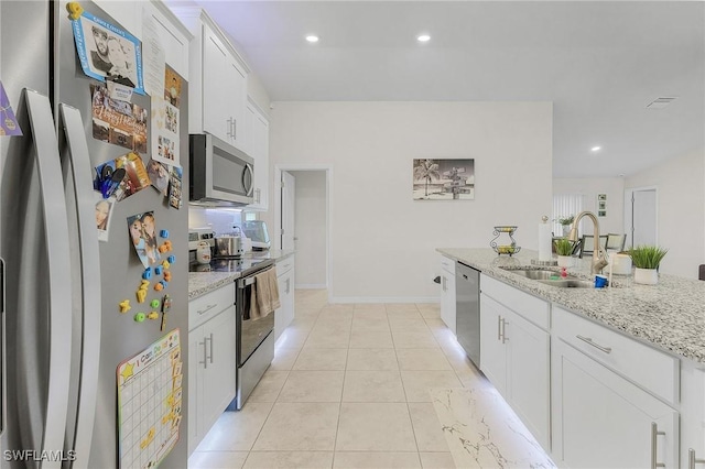 kitchen featuring light stone countertops, appliances with stainless steel finishes, sink, and white cabinets