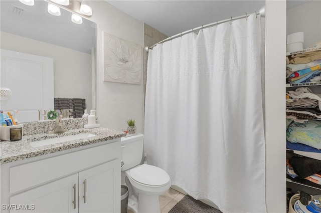 bathroom with tile patterned floors, toilet, and vanity