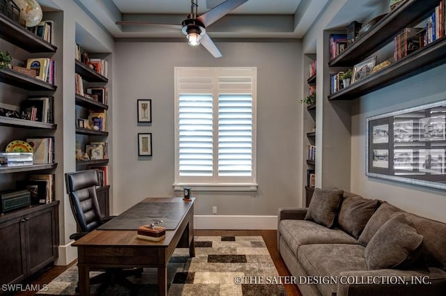 office featuring ceiling fan, built in shelves, and hardwood / wood-style flooring