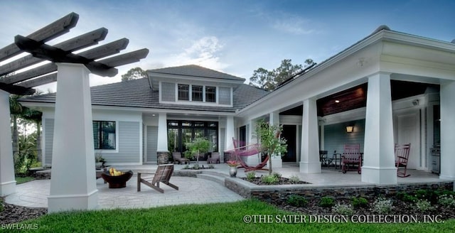 back of house featuring a fire pit