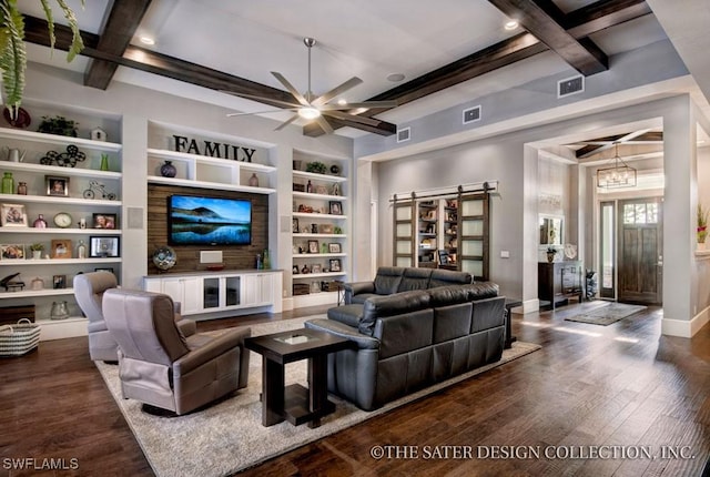 living room featuring built in features, a barn door, and beam ceiling