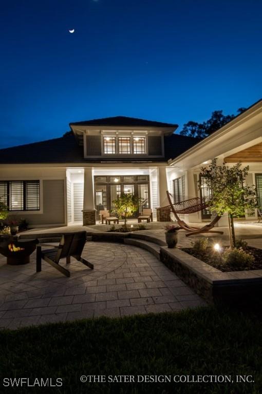 back house at night with a patio area