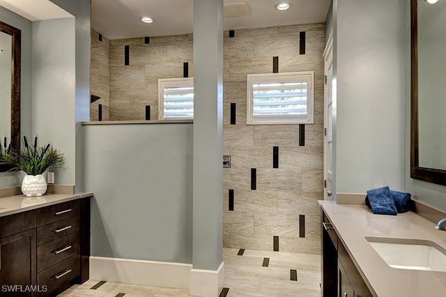 full bathroom featuring a stall shower, recessed lighting, and vanity