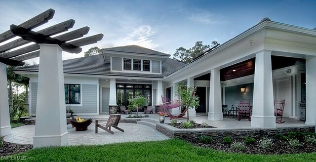 back of house with an outdoor fire pit