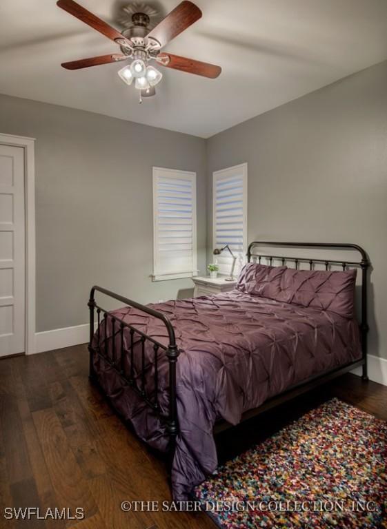 bedroom featuring a ceiling fan, baseboards, and dark wood-type flooring