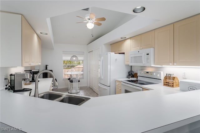 kitchen with vaulted ceiling, sink, white appliances, light tile patterned floors, and cream cabinetry