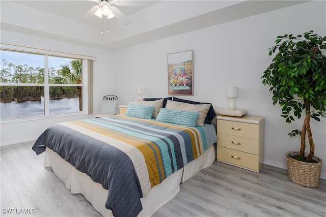 bedroom with ceiling fan and light hardwood / wood-style flooring