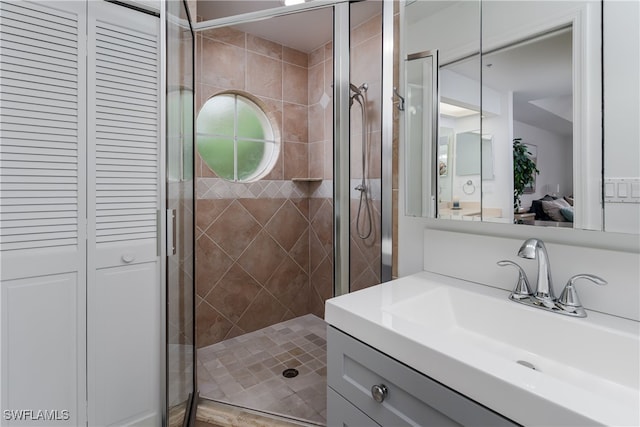 bathroom featuring walk in shower and vanity