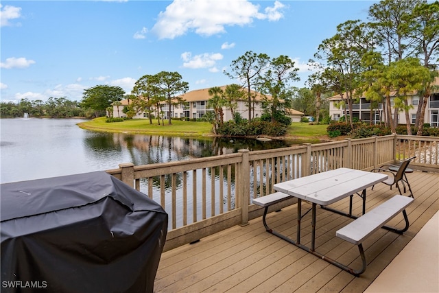 wooden deck featuring a grill and a water view