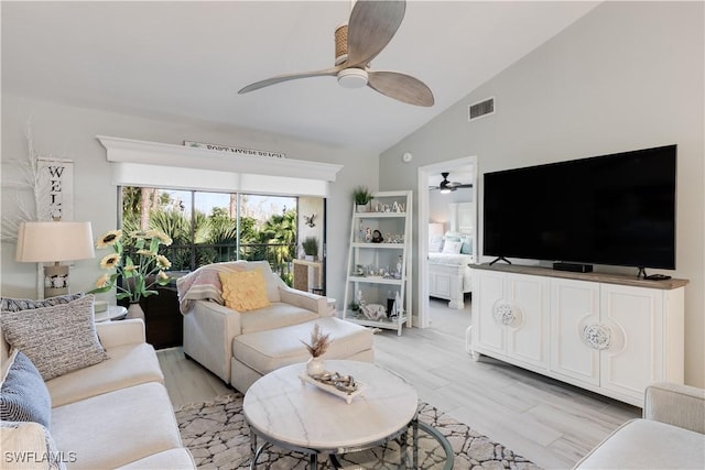 living room featuring lofted ceiling and light wood-type flooring