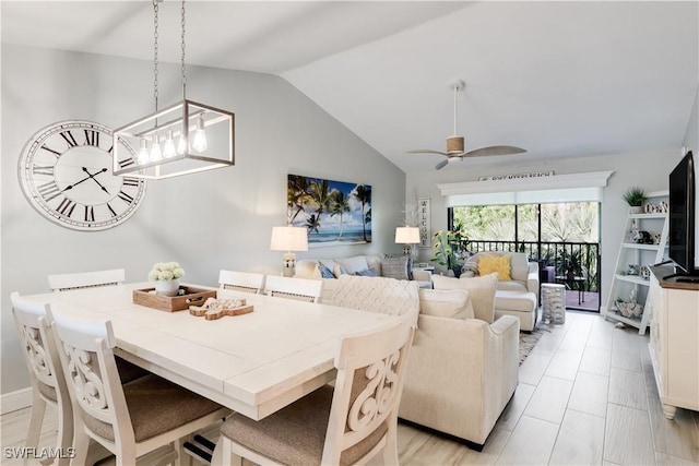 dining space featuring ceiling fan and lofted ceiling