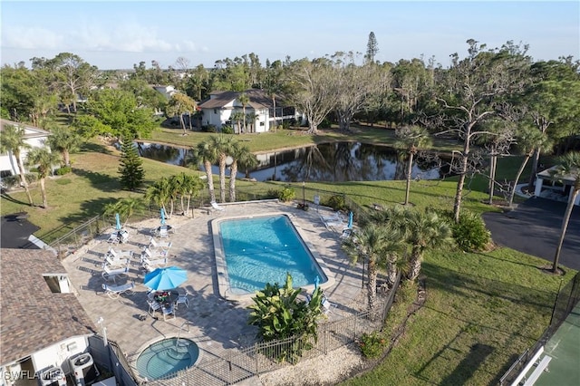 view of swimming pool featuring a yard, a community hot tub, a water view, and a patio