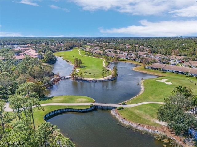 birds eye view of property with golf course view, a water view, and a residential view