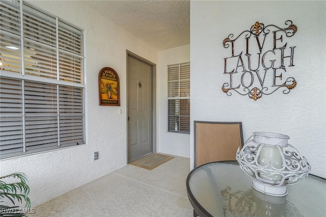 entrance to property with stucco siding