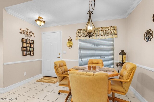dining space featuring baseboards, ornamental molding, a chandelier, and light tile patterned flooring
