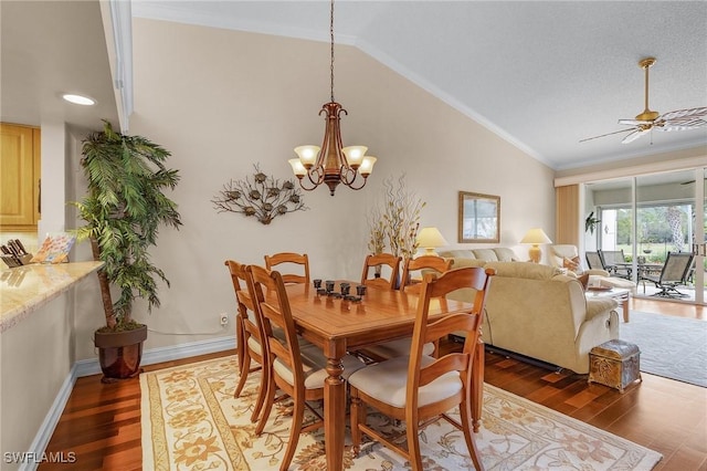 dining room featuring ornamental molding, wood finished floors, ceiling fan with notable chandelier, and vaulted ceiling
