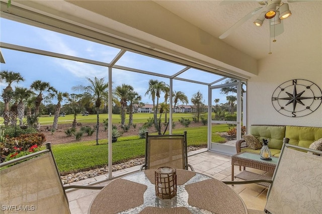sunroom / solarium featuring ceiling fan