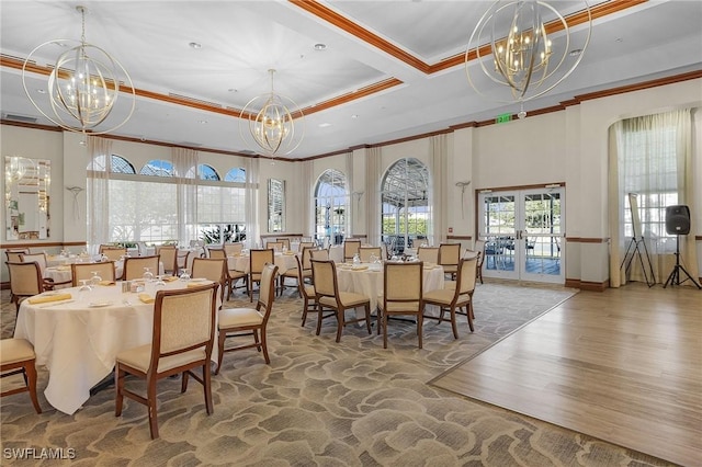 dining area featuring an inviting chandelier, crown molding, and a high ceiling