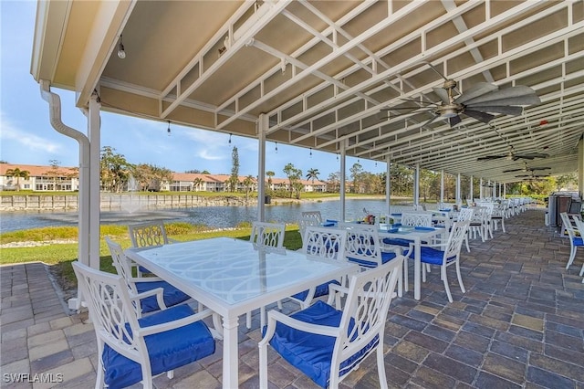 view of patio with outdoor dining area and a water view