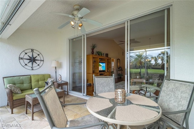 sunroom featuring ceiling fan