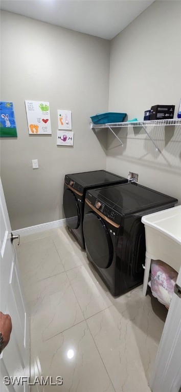 clothes washing area featuring separate washer and dryer