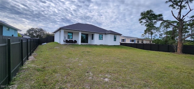 rear view of house with a lawn