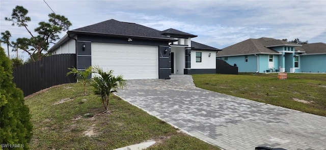 view of front of house with a front yard and a garage