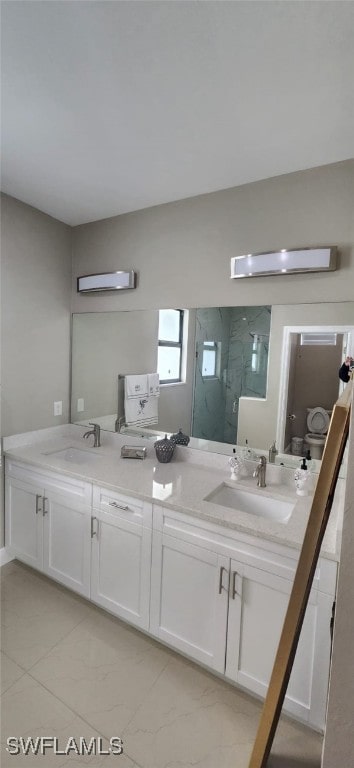 bathroom with vanity and a shower with shower door