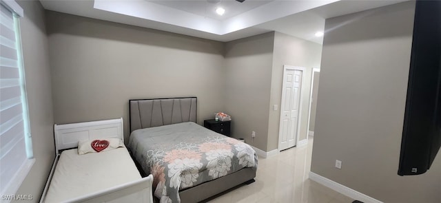 bedroom featuring ceiling fan and a tray ceiling