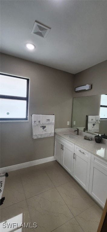 bathroom with vanity and a wealth of natural light