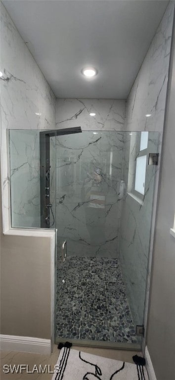 bathroom with a shower with shower door