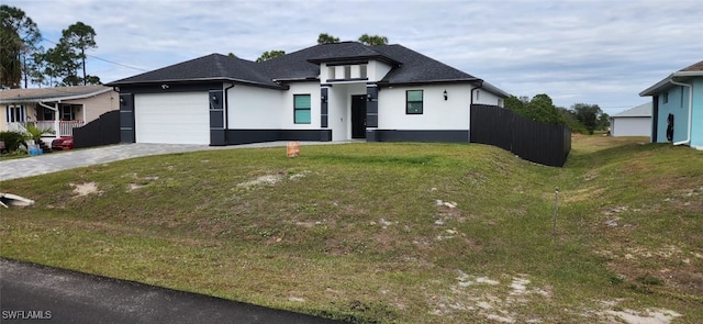 view of front of house featuring a front yard and a garage