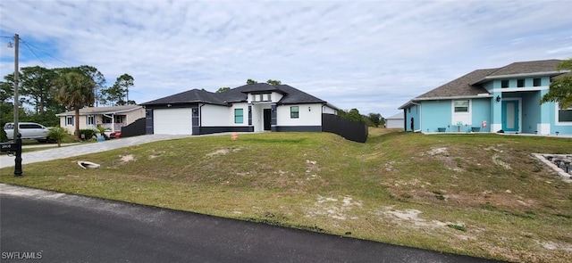 view of front of property with a front yard and a garage